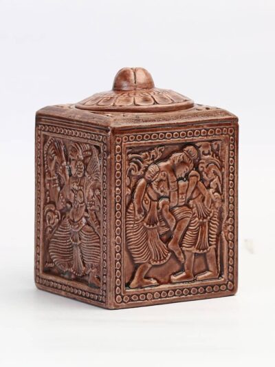 A carved wooden container with black tea