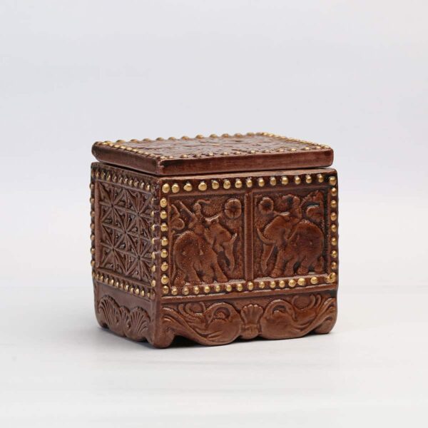 A beautifully carved tea chest with black tea